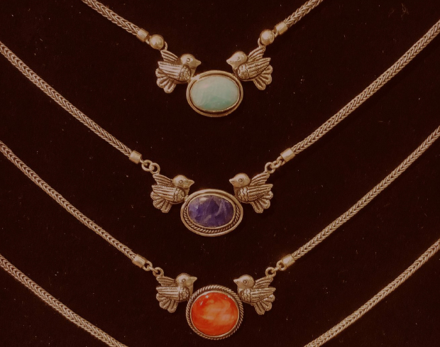  Three pendant necklaces, featuring birds on the side of the central pendant